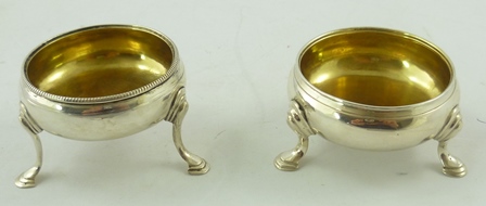 POSSIBLY WILLIAM JUSTIS TWO SIMILAR GEORGE II SILVER SALTS each circular with one beaded rim, gilt