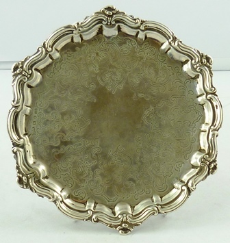 ROBERTS & HALL A VICTORIAN SILVER WAITER having cast and applied floral and scroll border,