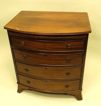 A 1960`s/70`s GEORGIAN STYLE MAHOGANY BOW FRONTED CHEST having brushing slide, four graduated long