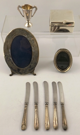 A SELECTION OF SILVER ITEMS, comprising two oval Photograph Frames, a small Trophy Cup, a square