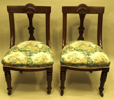 A PAIR OF VICTORIAN MAHOGANY RACK BACK DINING CHAIRS each having overstuffed seat and turned