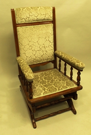 AN EARLY 20TH CENTURY BEECH FRAMED AMERICAN STYLE ROCKING ARMCHAIR, with floral flock upholstered