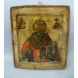 19TH CENTURY RUSSIAN SCHOOL
An Icon, half length of the Christ Pantocrator holding the Holy book,