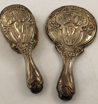 CHARLES WESTWOOD & SONS A SILVER BACKED HAND MIRROR AND CLOTHES BRUSH each having Art Nouveau