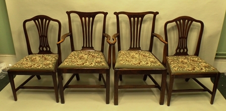 A PAIR OF EARLY 19TH CENTURY MAHOGANY DINING CHAIRS each having a hump crest rail, fan splat, drop-