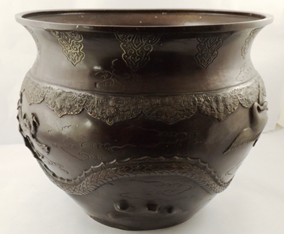 A LATE 19TH/EARLY 20TH CENTURY JAPANESE BRONZE JARDINIERE repousse worked in relief with a dragon