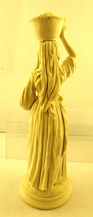 A BELLEEK PORCELAIN FIRST PERIOD PARIAN FIGURINE of a basket carrying female in multi-layered attire - Image 3 of 3