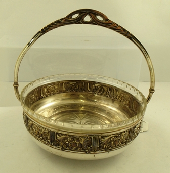 A WMF STYLE ELECTRO-PLATED BOWL with up and over handle and foliate surround, with lead crystal