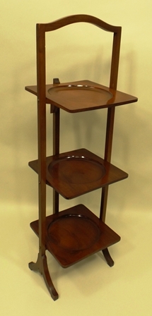 AN EARLY 20TH CENTURY MAHOGANY FINISHED THREE TIER FOLDING CAKE STAND with square supports, - Image 2 of 2