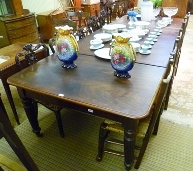A VICTORIAN MAHOGANY EXTENDING DINING TABLE having twin squared ends with rounded corners, raised on - Image 2 of 3