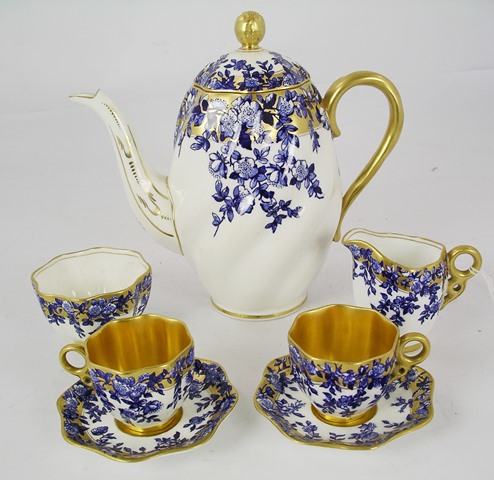 A COALPORT PORCELAIN DEMI TASSE COFFEE SET decorated in underglaze blue and white with leaves and