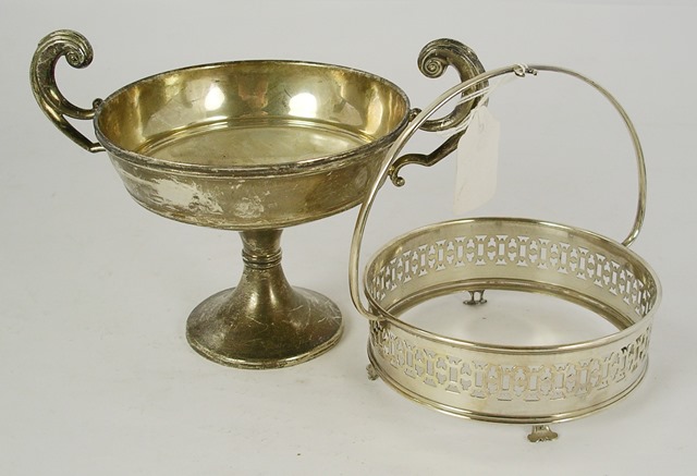 MARKS RUBBED A SILVER TWO HANDLED TROPHY CUP having up-scrolled handles, ring stem and circular