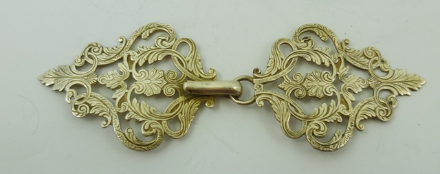 A CONTINENTAL SILVER COLOURED METAL NURSE`S BUCKLE, fretted and worked with acanthus and palmettes,