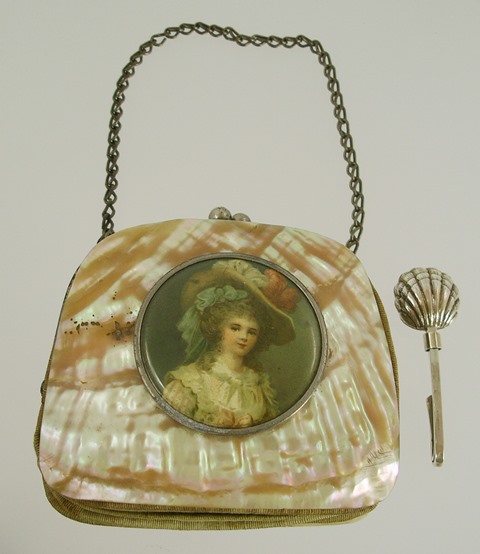 A LATE VICTORIAN/EDWARDIAN MOTHER-OF-PEARL FLANKED PURSE set with a vignette of a young girl,