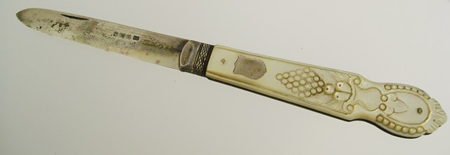 E** B** A VICTORIAN SILVER AND MOTHER-OF-PEARL HANDLED FRUIT KNIFE, having carved decorated handle