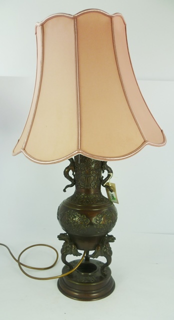 A 20TH CENTURY ORIENTAL BRONZE VASE (now fitted for electricity) having dragon handles, baluster