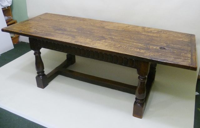 A PART 19TH CENTURY OAK PLANK TOPPED REFECTORY TABLE with carved frieze, supported on four turned