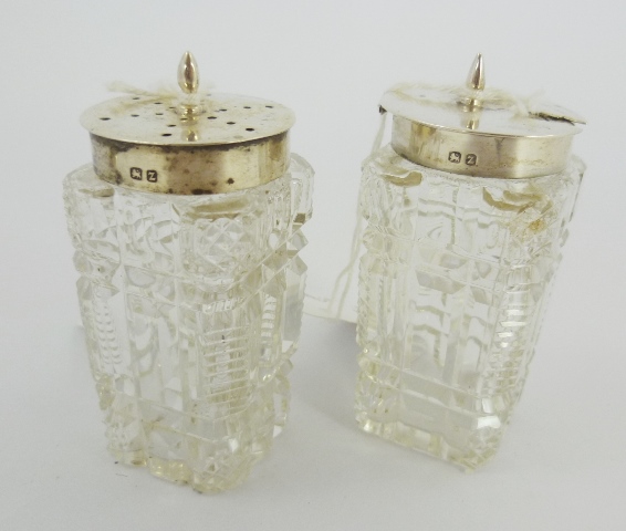 A SILVER TOPPED MUSTARD with cut glass base and MATCHING SILVER TOPPED PEPPER, Birmingham 1899, 7.