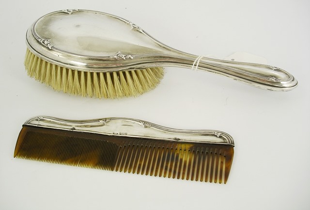 SAMUEL M. LEVI A SILVER BACKED LADY`S DRESSING TABLE SET comprising hair brush and matching comb,