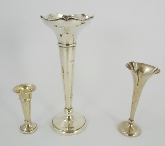 THREE SILVER BUD VASES two with fluted bowls and one plain, each with tapering stem and circular