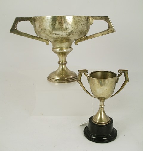 EDWARD VINER A SILVER TWO HANDLED TROPHY CUP having folded rim, angular handle and knopped stem,