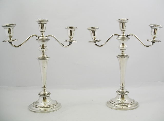 A PAIR OF AMERICAN SILVER COLOURED METAL THREE LIGHT, TWO BRANCH CANDELABRA, each having detachable