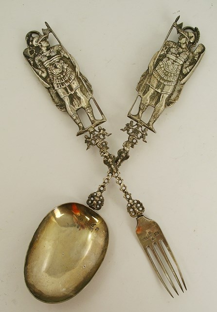 A PAIR OF 19TH CENTURY FOREIGN SILVER SALAD SERVERS, each having generous cast handles with standing