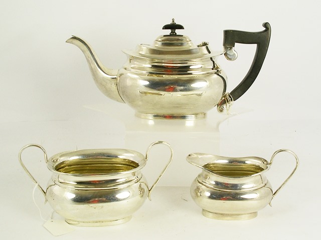 EDWARD VINER A SILVER THREE-PIECE TEA SET, each of oblong/oval bellied form, teapot with black fibre