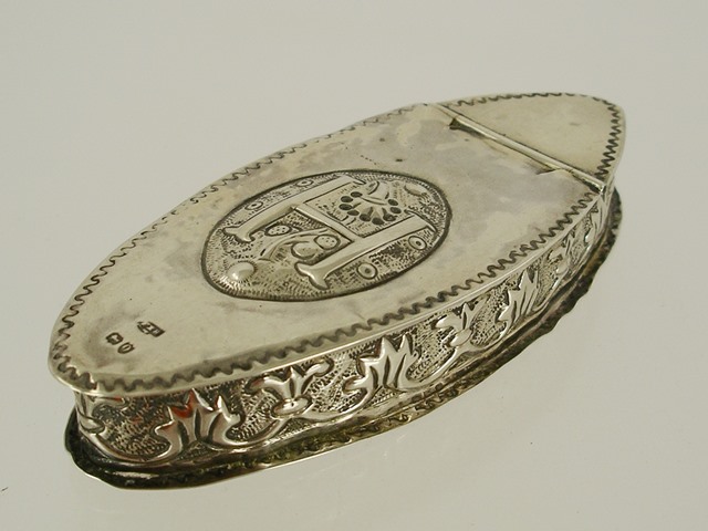 ** G* H** A NAVETTE SHAPE SILVER PILL BOX having three-quarter hinged lid with repousse roundel,