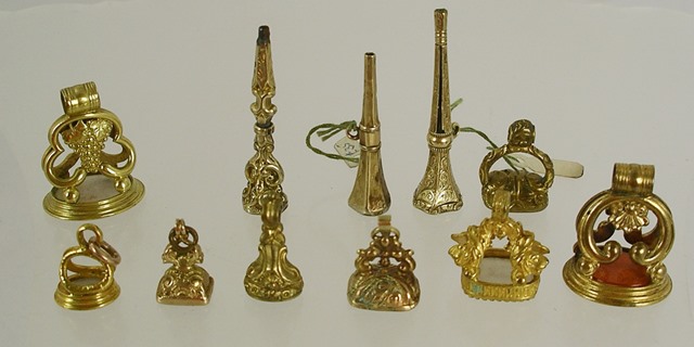 A COLLECTION OF FOB SEALS, seven in pinchbeck or gilt metal set with agate, cornelian and