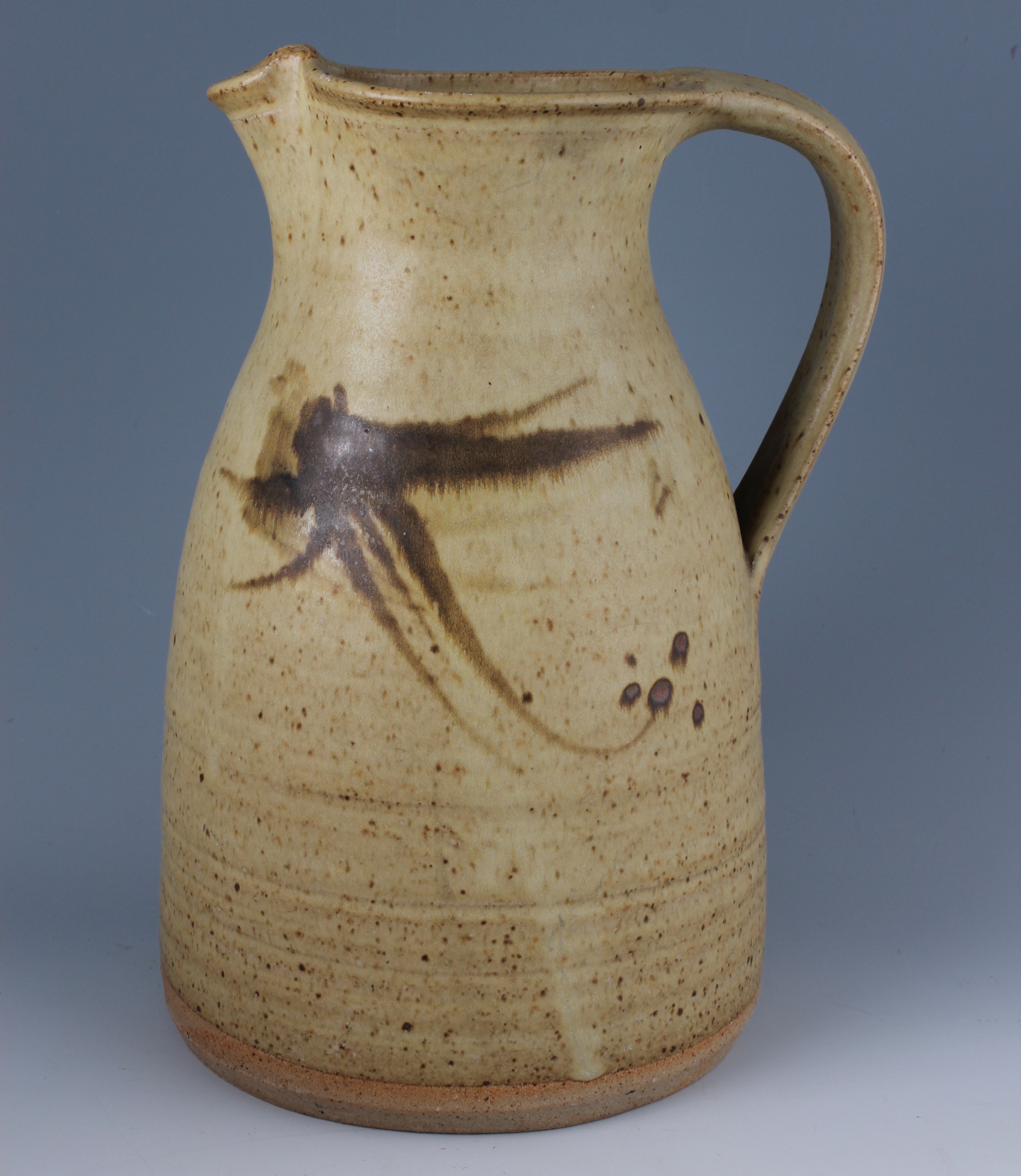 A studio pottery jug by Russell Collins b. 1942, of tapering necked form, the thrown body with