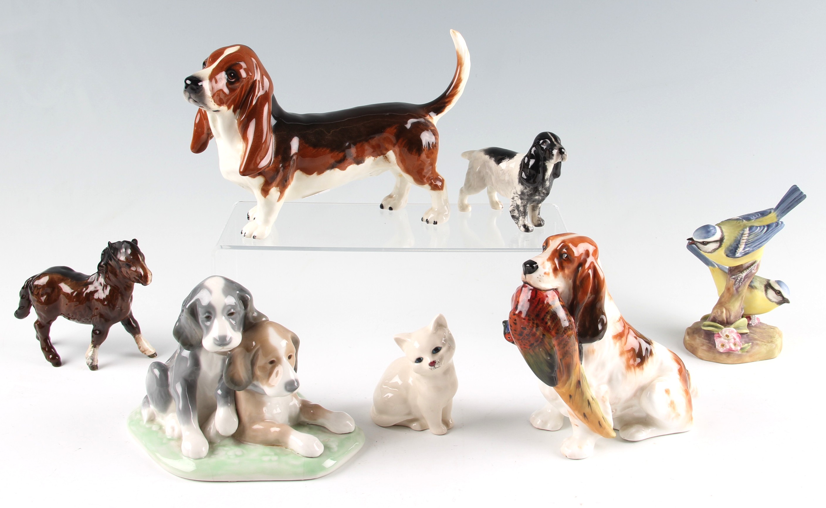 A parcel lot of animal figures to include Royal Doulton Cocker spaniel HN 1028 by F Daws, another