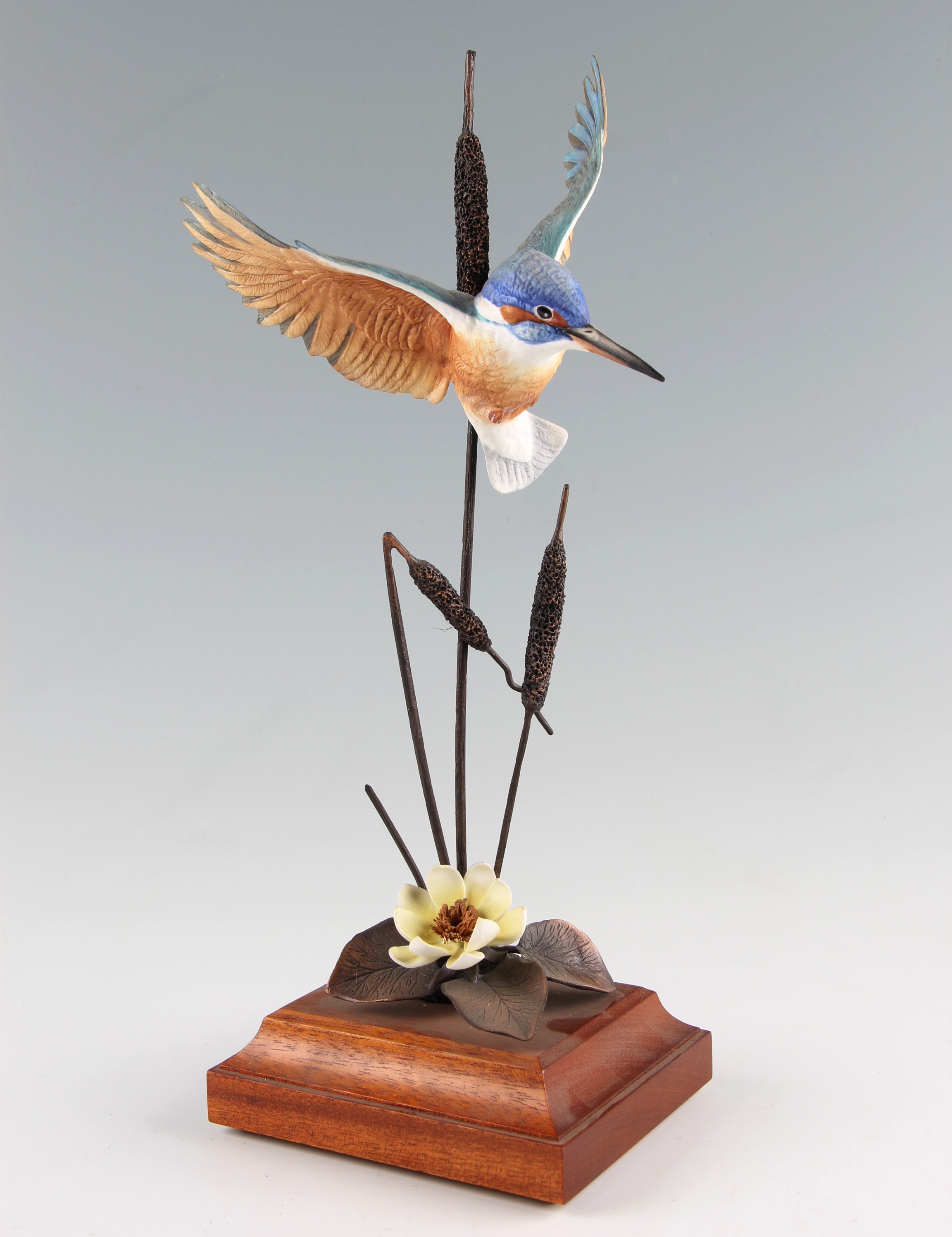 A David Fryer Studios bronze and porcelain figure of a kingfisher on bulrushes, with flower below,