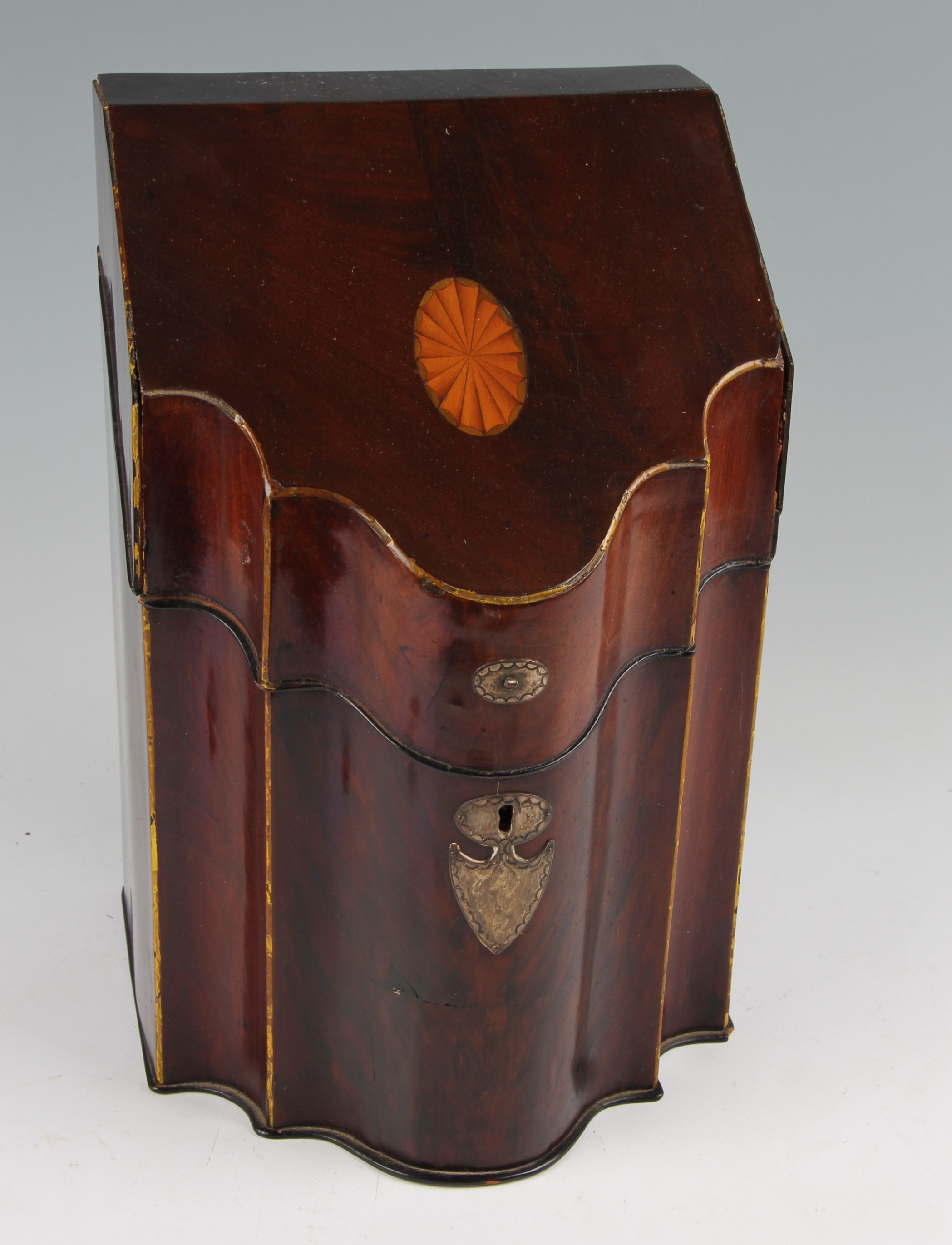 A George III mahogany knife box, the serpentine front with white metal shield cartouche lock plate,