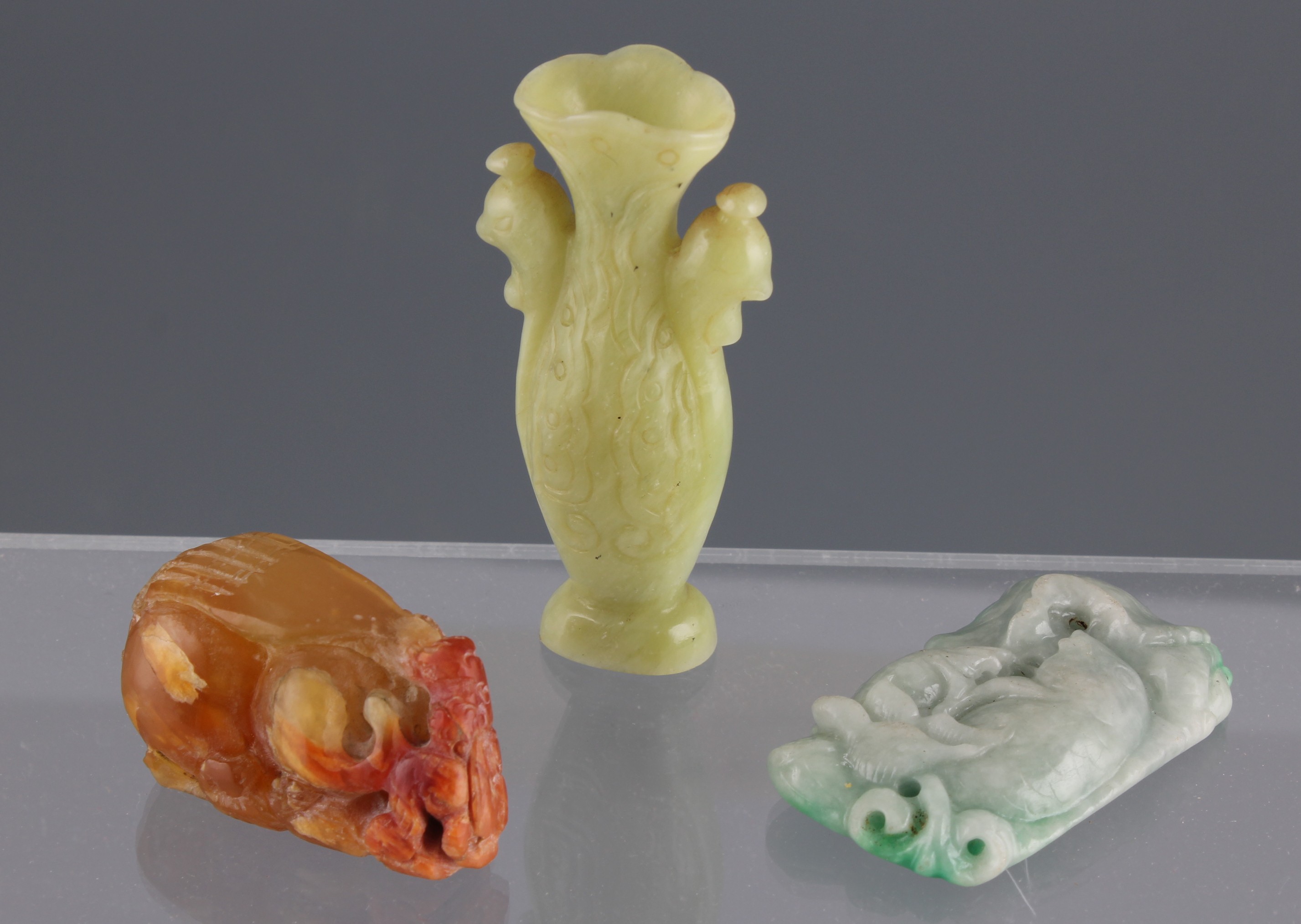 Three Chinese jade and stone carvings to include miniature vase with Fenghuang bird heads to