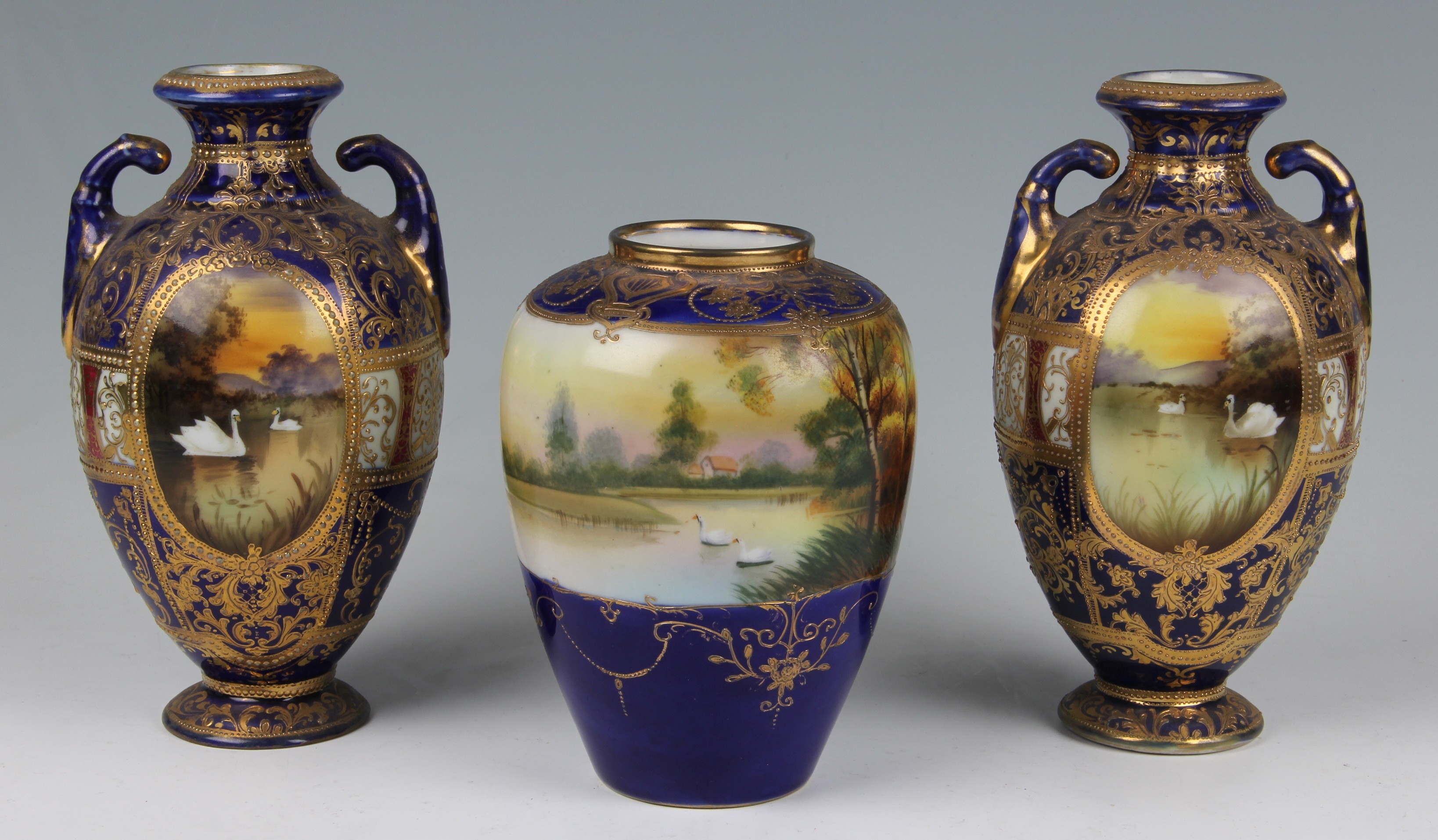 Three pieces of Noritake to include a pair of tapering footed vases, with another, all deep blue