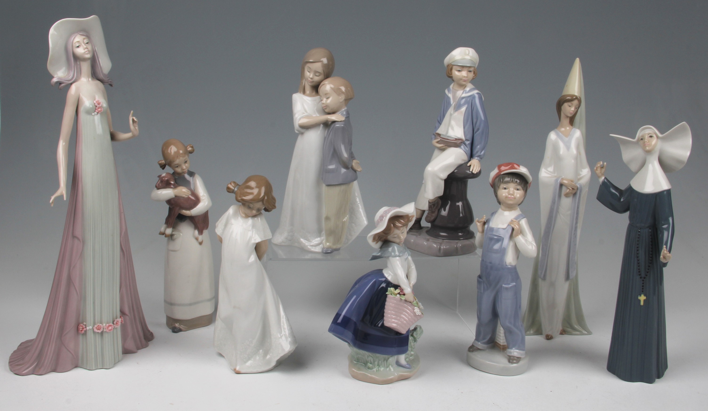 A parcel lot of six Lladro and two Nao figures to include girl with lamb, Call to prayer nun 5551,