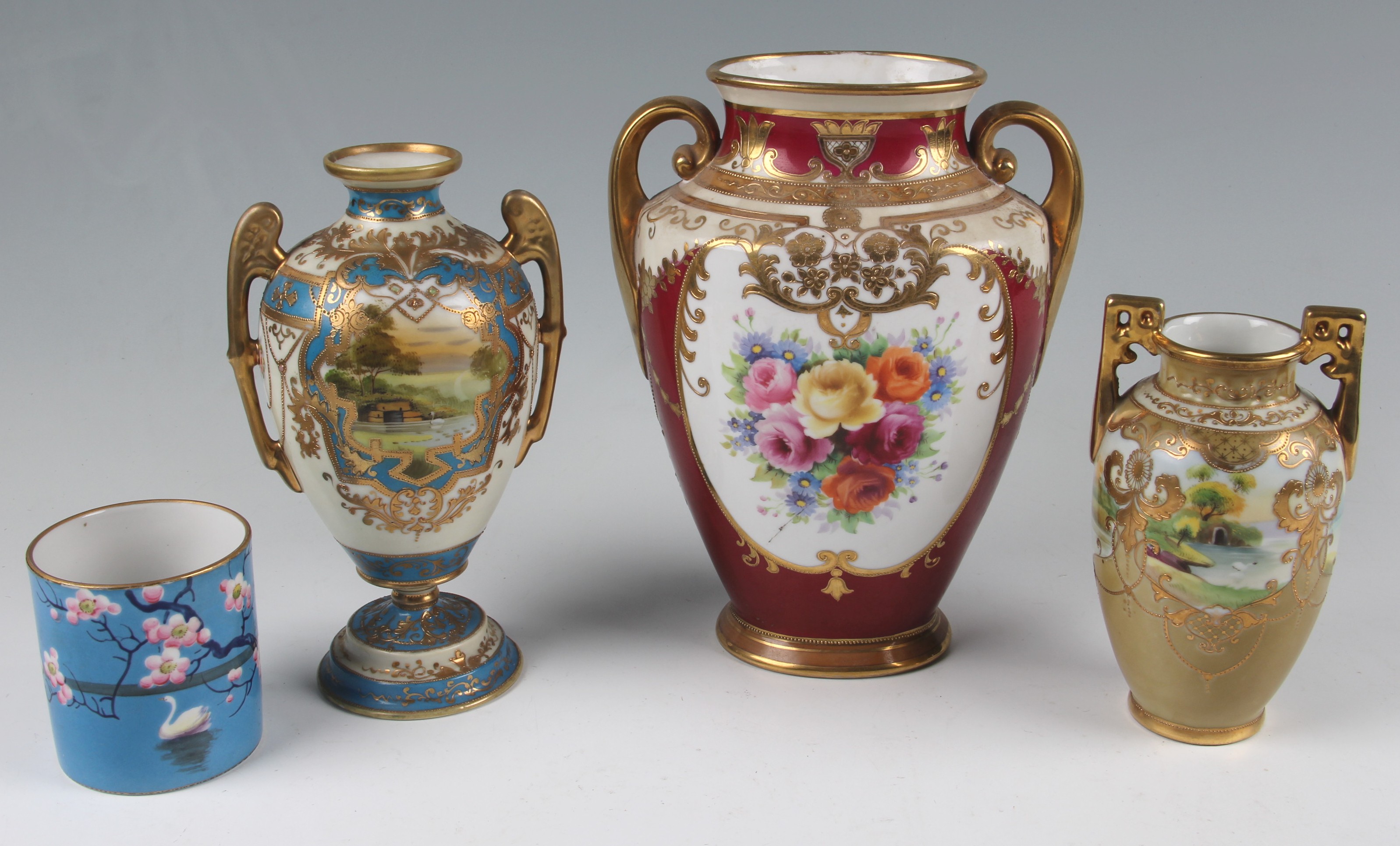 A group of four pieces of Noritake to include three vases, one of footed urn form, with blue and