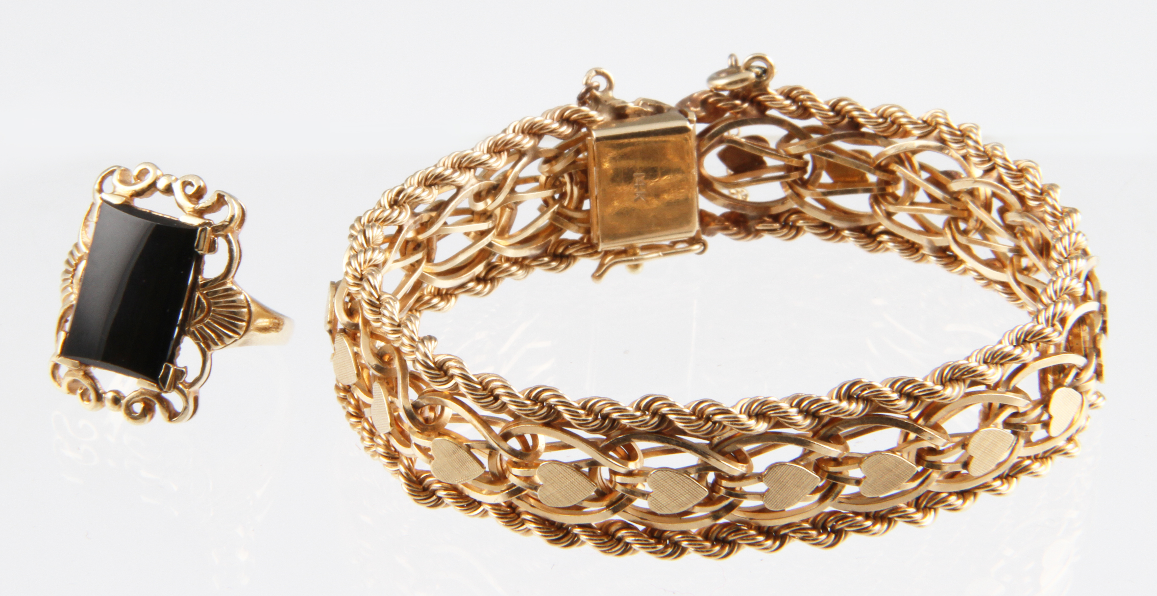 A 14k yellow gold bracelet with rope border detail with central linking and heart motif detail,
