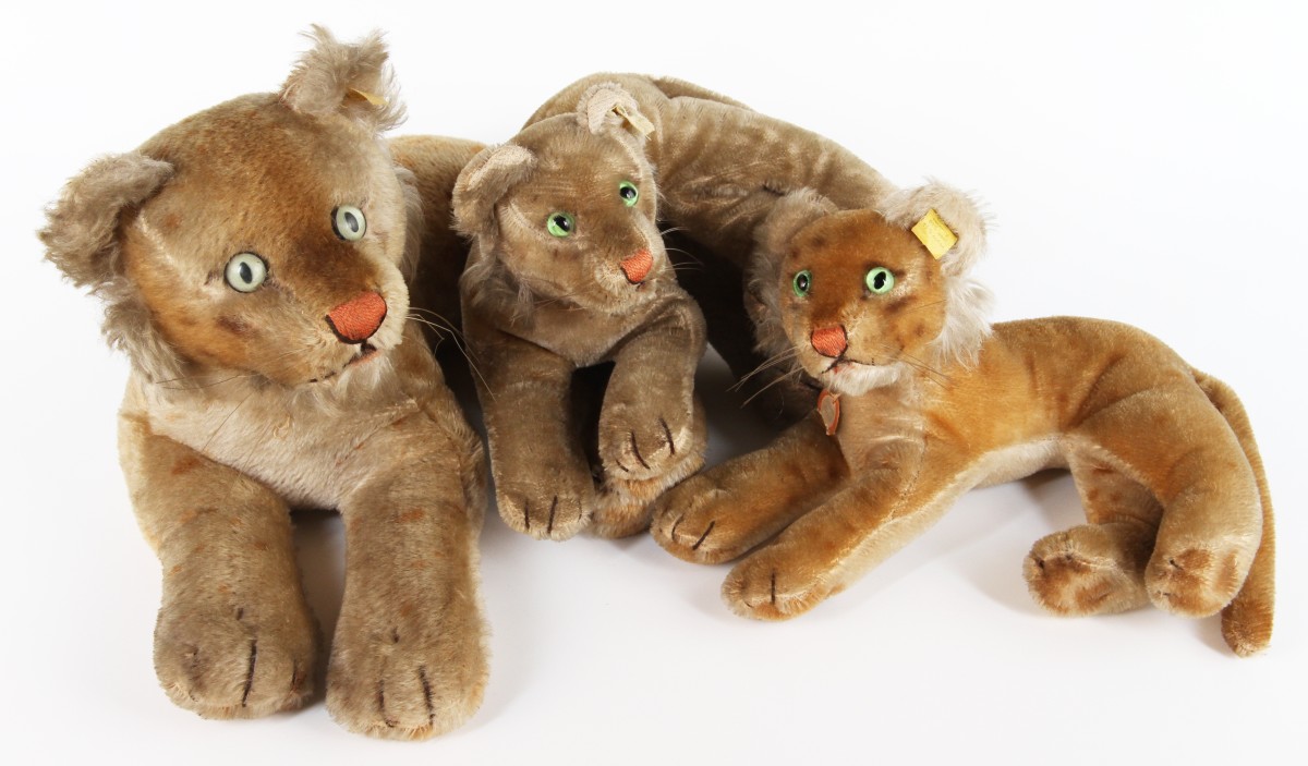 A group of three mid 20th Century Steiff toys, of a recumbent lioness with two cubs, mohair