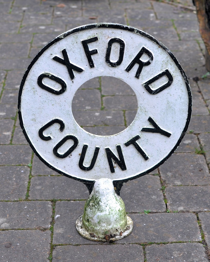 A painted cast iron `Oxford County` circular Road Sign.