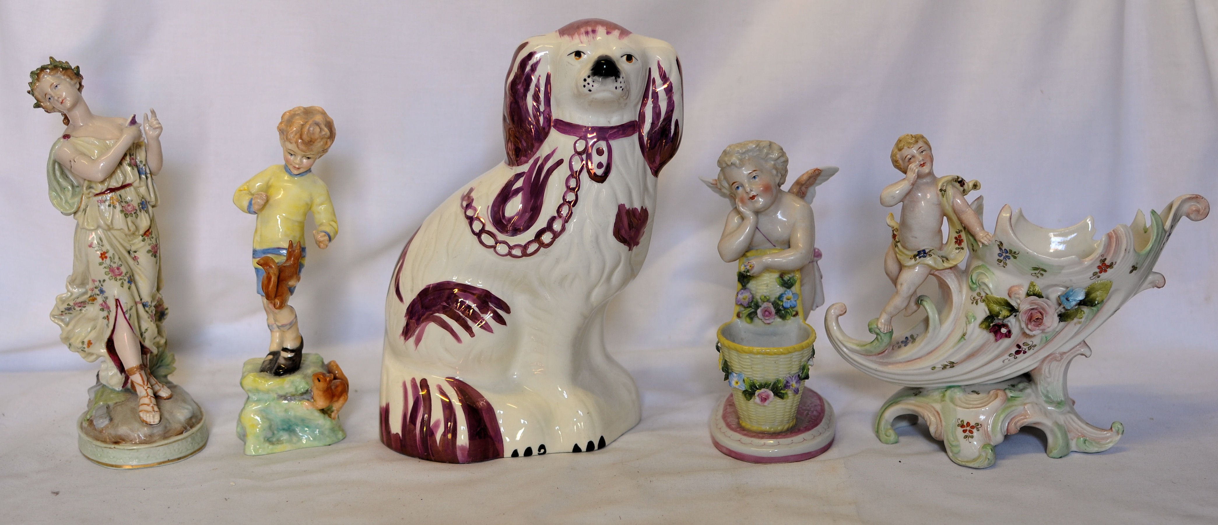 A Royal Worcester figure `October` modelled by F C Doughty and a Beswick pink lustre spaniel.