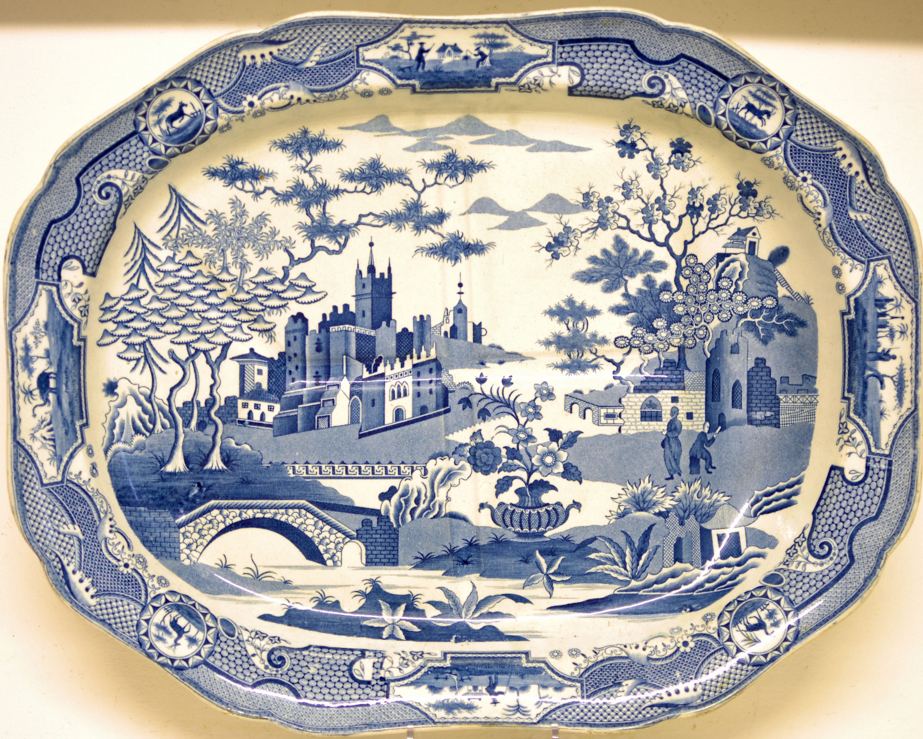 A 19th Century Earthenware Meat Plate with gravy well, printed in blue and white with an Oriental
