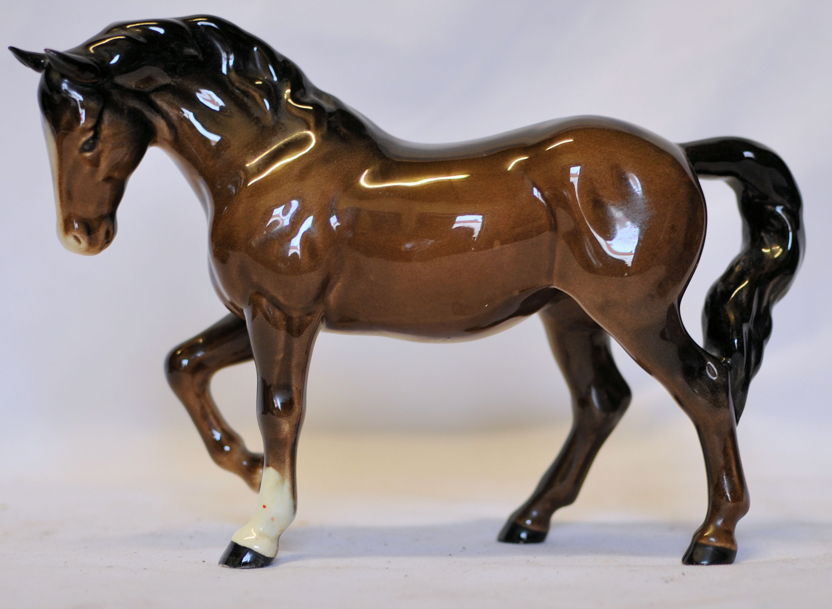 A Beswick stocky jogging brown Mare, no. 855, 3rd version and a Royal Doulton horse.