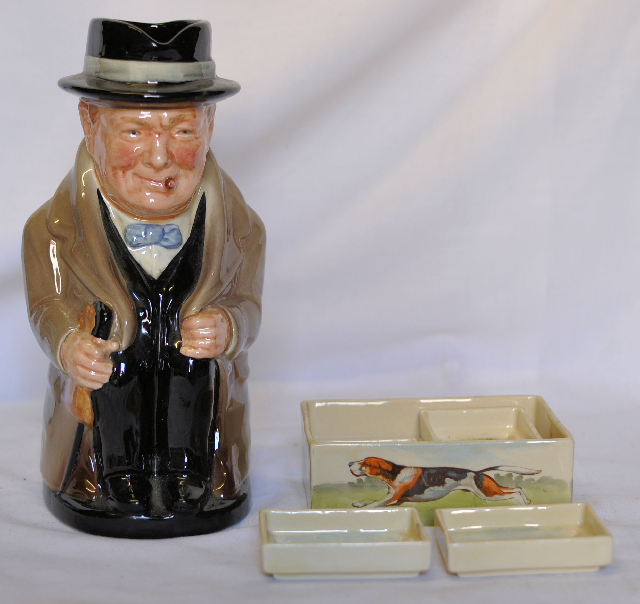 A Royal Doulton Character Jug `Winston Churchill`, 9"" (23cms) high and a Doulton tobacco set