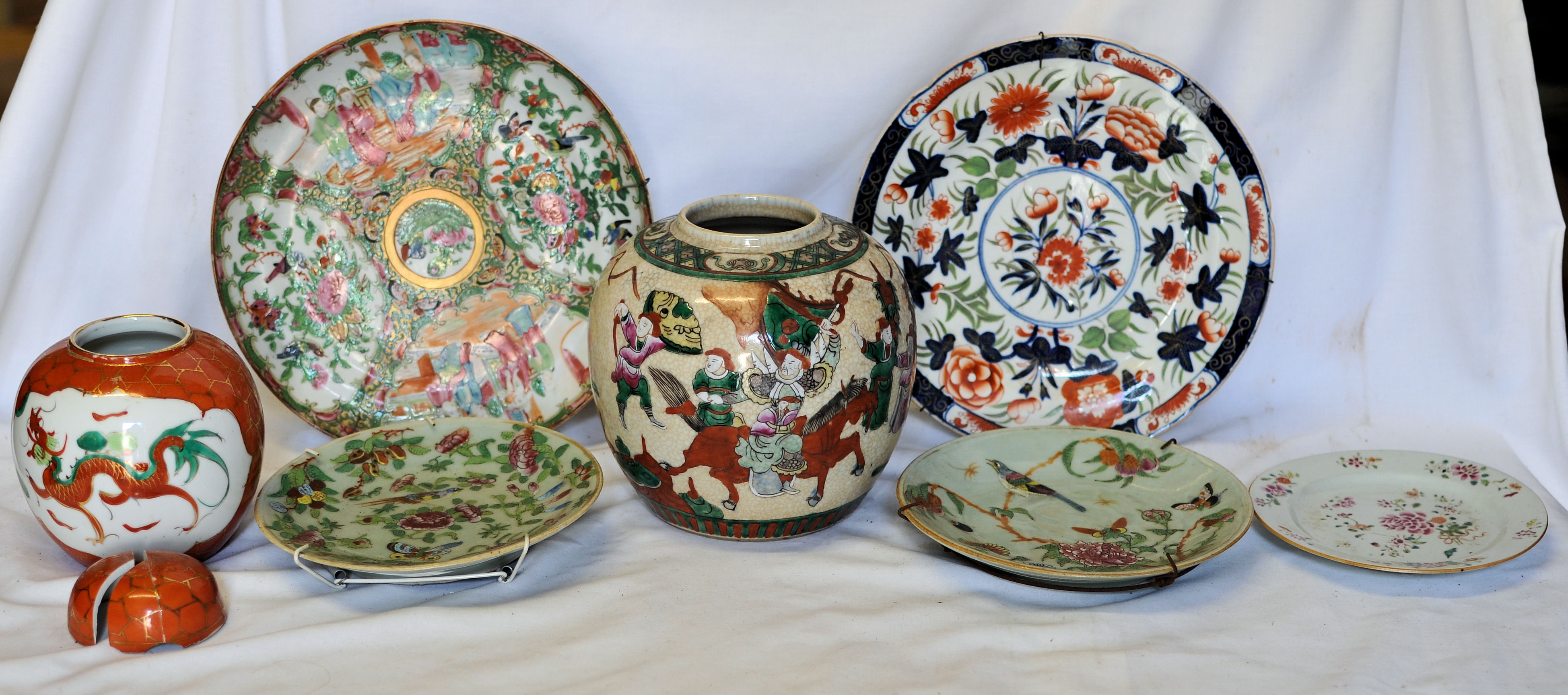 A Cantonese Plate decorated with panels of figures and flowers, 10"" (26cms) diameter, an Imari