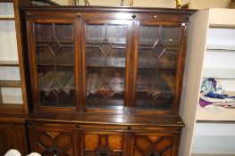 An oak three door bookcase with moulded cornice, below 3 glazed doors and 3 panelled doors,