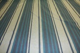 A large roll of turquoise toned striped fabric. Approx. 30m plus