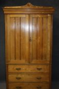 A Victorian linen press with moulded cornice below two panelled doors, above three long drawers,