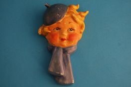 A Goebel Hummel wall mask of a young girl wearing a hat and scarf. 15 cm long
